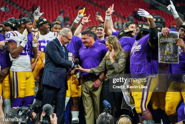 Championship Game: LSU coach Ed Orgeron victorious shaking hands with SEC commissioner Greg Sankey during interview on field with CBS sideline...