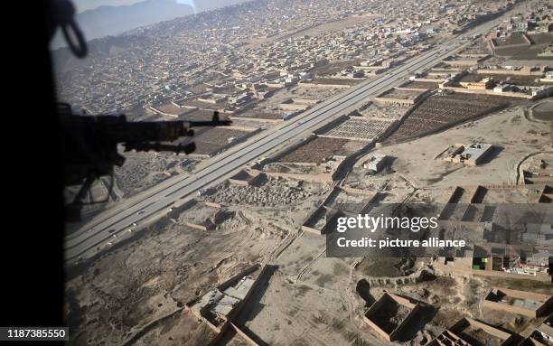 December 2019, Afghanistan, Kabul: View from an armed military helicopter on Afghanistan's capital Kabul. Photo: Britta Pedersen/dpa-Zentralbild/ZB