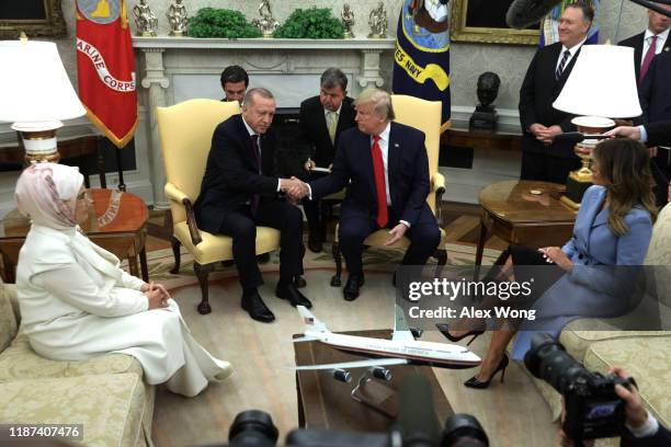 President Donald Trump shakes hands with Turkish President Recep Tayyip Erdogan as U.S. First lady Melania Trump and Turkish first lady Emine Erdogan...