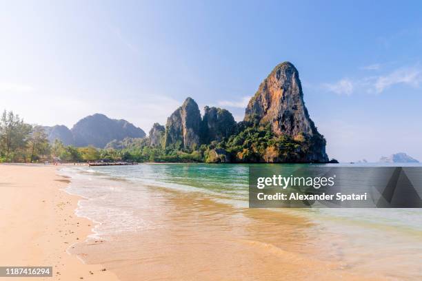 railay beach on a sunny day with clear blue sky, krabi, thailand - krabi stock pictures, royalty-free photos & images