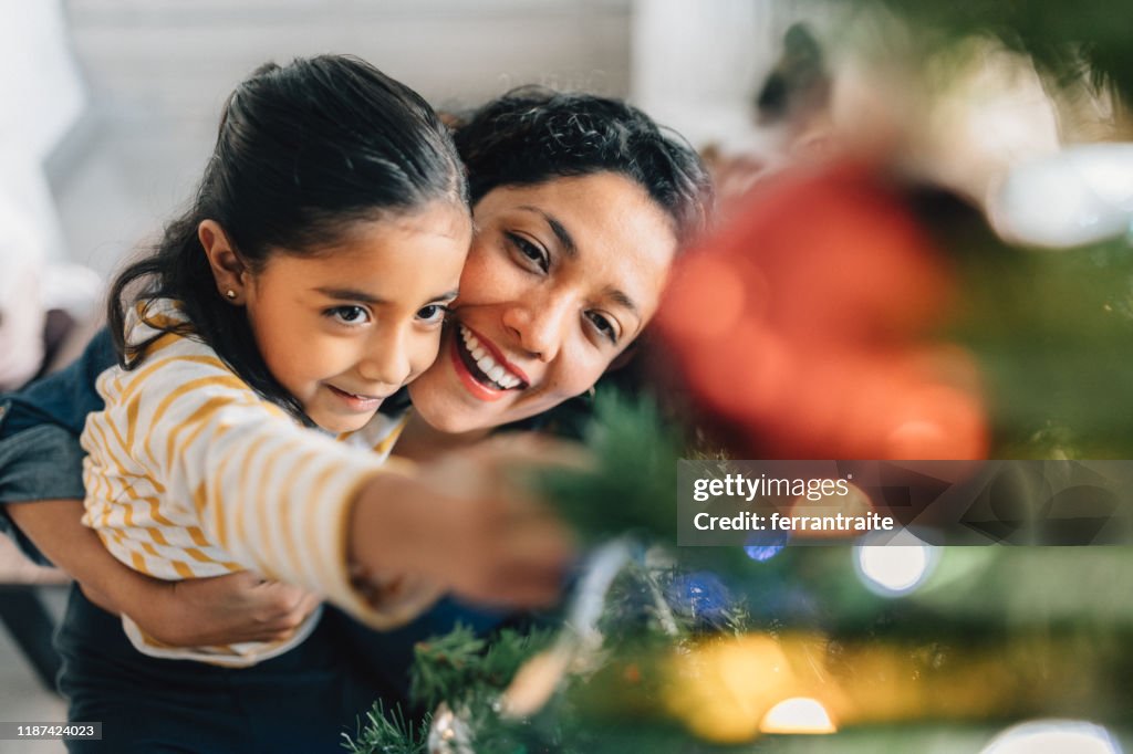 Mother and daughter decorating Christmas Tree