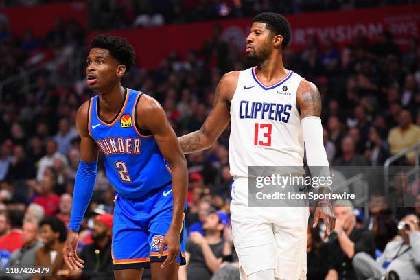 Oklahoma City Thunder Guard Shai Gilgeous-Alexander and Los Angeles Clippers Guard Paul George and look on during a NBA game between the Oklahoma...