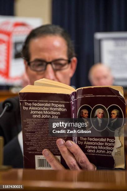 Rep. Jamie Raskin reads a copy of The Federalist Papers during a House Judiciary Committee hearing questioning staff lawyer Stephen Castor,...