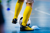 Futsal soccer training. Single young futsal player with ball on training. Close up of legs of futsal footballer. Indoor european football practice unit