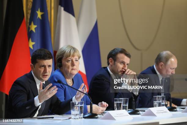 Ukrainian President Volodymyr Zelensky, German Chancellor Angela Merkel, French President Emmanuel Macron and Russian President Vladimir Putin give a...