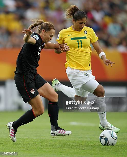 Cristiane of Brazil in action with Christie Rampone of USA during the Women's World Cup Quarter Final match between Brazil and USA at Rudolf-Harbig...