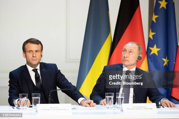 Emmanuel Macron, France's president, left, and Vladimir Putin, Russia's president, attend a news conference following a 4-way summit on Ukraine at...