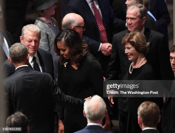 Former Presidents Barach Obama and George Bush with their wives Michelle and Barbara talks with former VP Al Gore at the funeral service at the...