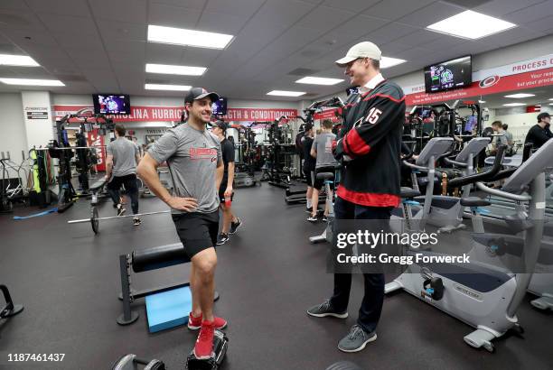 Nino Niederreiter of the Carolina Hurricanes chats in the weight room with American professional tennis player John Isner following an NHL game...