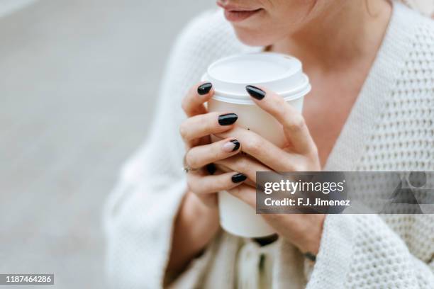 close-up of woman's hands with take away drink - fingernail stock photos et images de collection