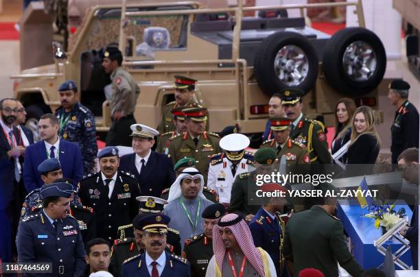 Visitors attend the Fifth Gulf Defence and Aerospace exhibition in Kuwait City on December 10, 2019. - Exhibitors meet professionals from the...