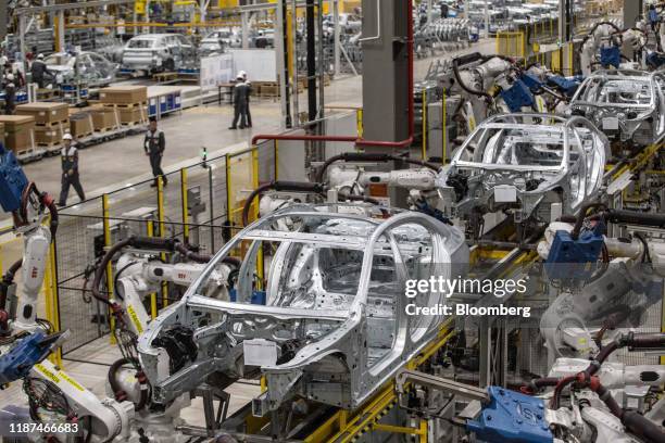 Robotic arms work on the body frames of Vinfast Lux A2.0 sedans in the body shop area of the automaker's factory in Haiphong, Vietnam, on Wednesday,...