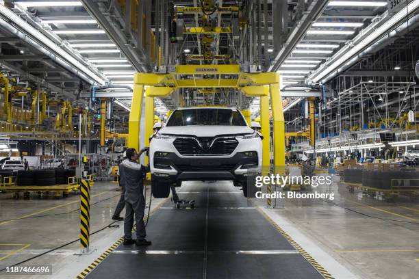 Workers labor on a Vinfast Lux SA2.0 sports utility vehicle moving along a conveyor at the automaker's factory in Haiphong, Vietnam, on Wednesday,...