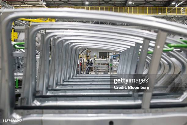 Workers is seen through a line of rear doors of Vinfast Lux A2.0 sedans in the body shop area of the automaker's factory in Haiphong, Vietnam, on...