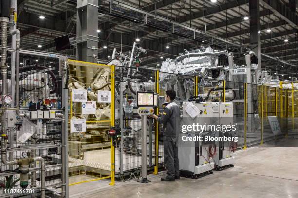 Worker monitors robotic arms operating in the body shop area of the automaker's factory in Haiphong, Vietnam, on Wednesday, Dec. 4, 2019. Vingroup...