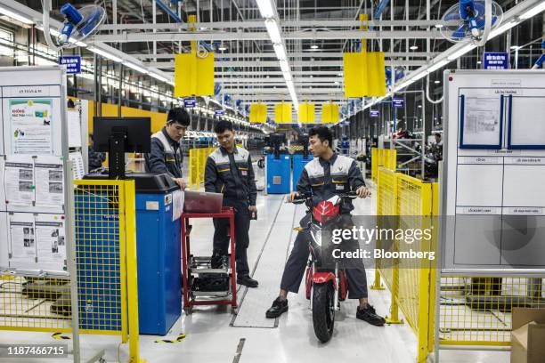 Worker do a final quality check of a Vinfast Impes electric scooter at the automaker's factory in Haiphong, Vietnam, on Wednesday, Dec. 4, 2019....