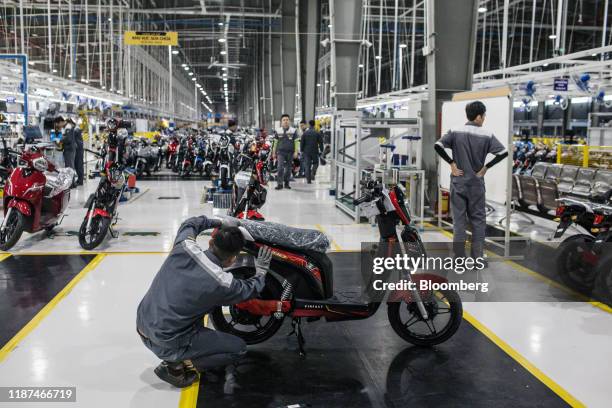 Worker does a final quality check of a Vinfast Impes electric scooter sit at the automaker's factory in Haiphong, Vietnam, on Wednesday, Dec. 4,...