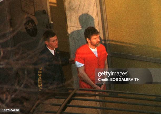 Unabomber suspect Theodore Kaczynski is lead out the Federal Courthouse by a US Marshal after a hearing to determine his competency 20 January in...