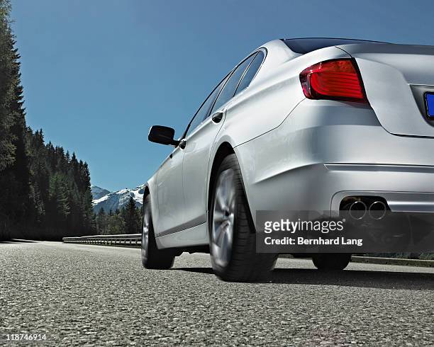 car driving up road in mountains - on the move rear view stockfoto's en -beelden