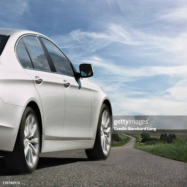 car driving down road, rear view - sedan stock pictures, royalty-free photos & images