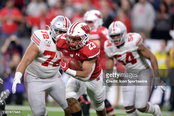 Wisconsin Badgers running back Jonathan Taylor runs with the ball during the Big Ten Conference Championship football game between the Wisconsin...