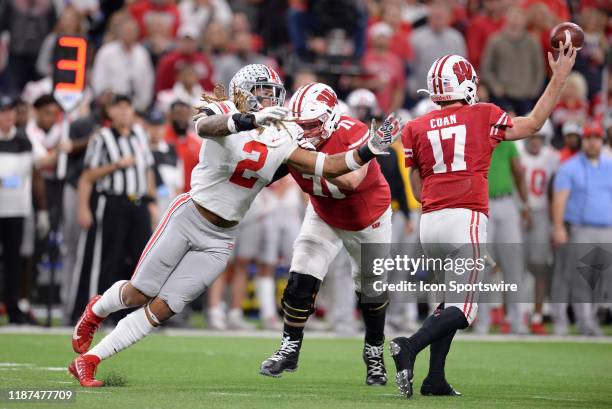 Wisconsin Badgers offensive lineman Cole Van Lanen shoves Ohio State Buckeyes defensive end Chase Young as Wisconsin Badgers quarterback Jack Coan...