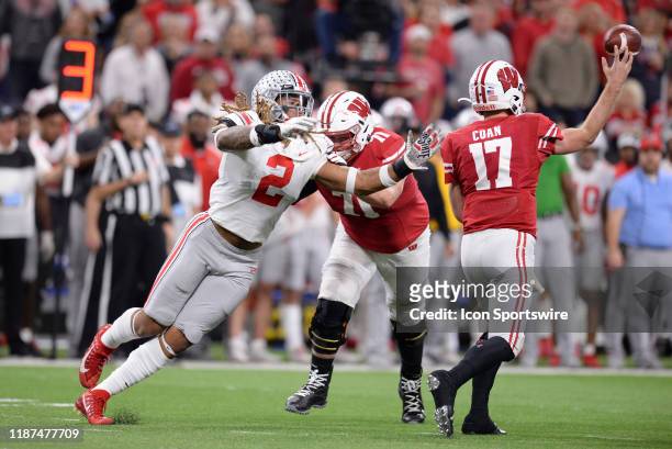 Wisconsin Badgers offensive lineman Cole Van Lanen shoves Ohio State Buckeyes defensive end Chase Young as Wisconsin Badgers quarterback Jack Coan...