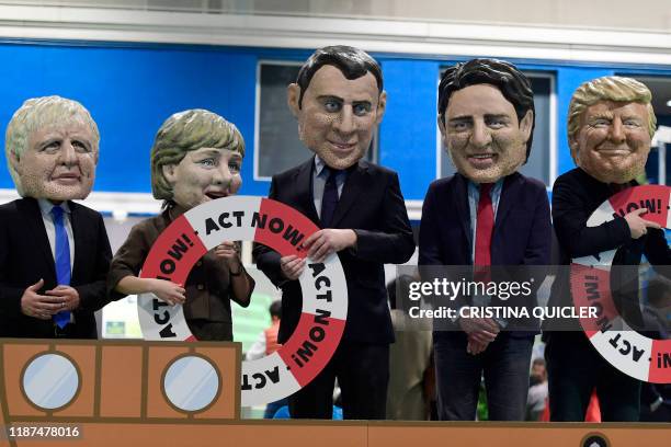 Five actors sporting bigheaded caricatures depicting British Prime Minister Boris Johnson, German Chancellor Angela Merkel, French President Emmanuel...