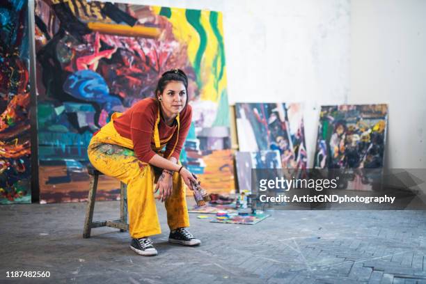 young woman artist in studio. - painted image stock pictures, royalty-free photos & images