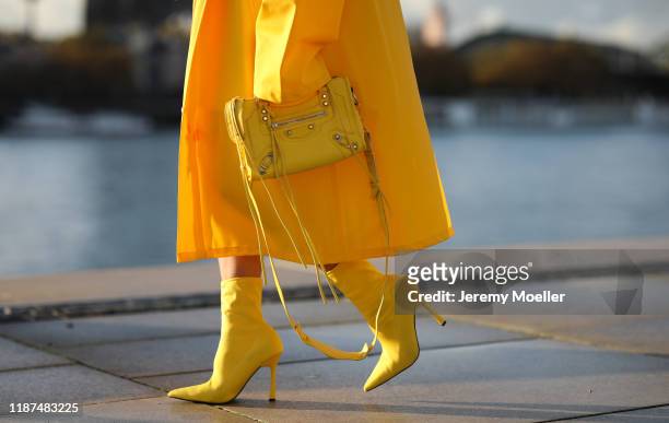 Palina Kozyrava wearing Vetements raincoat, Asos shoes and Balenciaga bag on November 04, 2019 in Cologne, Germany.