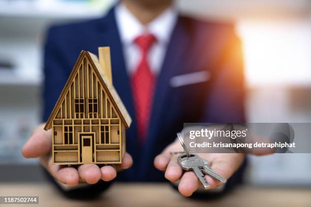 real estate agent and giving key to client,selling home,home sale, - real estate law stock pictures, royalty-free photos & images