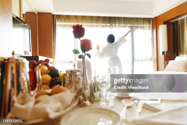 the young woman in a hotel room for coffee - roomservice stockfoto's en -beelden