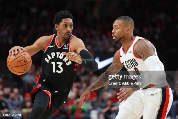 Malcolm Miller of the Toronto Raptors drives against Damian Lillard of the Portland Trail Blazers in the first quarter at Moda Center on November 13,...