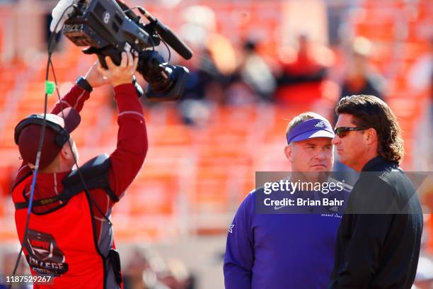 Head coach Gary Patterson of the TCU Horned Frogs talks with head coach Mike Gundy of the Oklahoma State Cowboys under the watch of an ESPN camera...