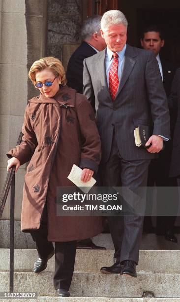 President Bill Clinton walks down the steps of Foundry Methodist Church with First Lady Hillary Clinton after they attended services with their...