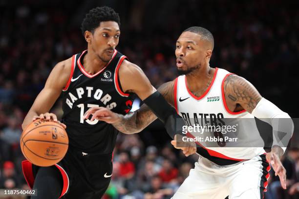 Malcolm Miller of the Toronto Raptors drives against Damian Lillard of the Portland Trail Blazers in the first quarter at Moda Center on November 13,...