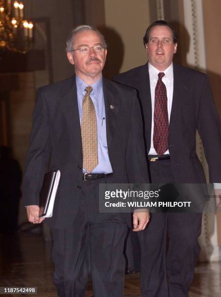 Rep Bob Barr and an unidentified man walk towards the US Senate 16 January to attend the third day of the US Senate impeachment trial of US President...