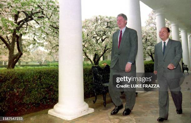 President Bill Clinton walks with Japanese Prime Minister Kiichi Miyazawa past apple trees adjacent to the Rose Garden at the White House 16 April...