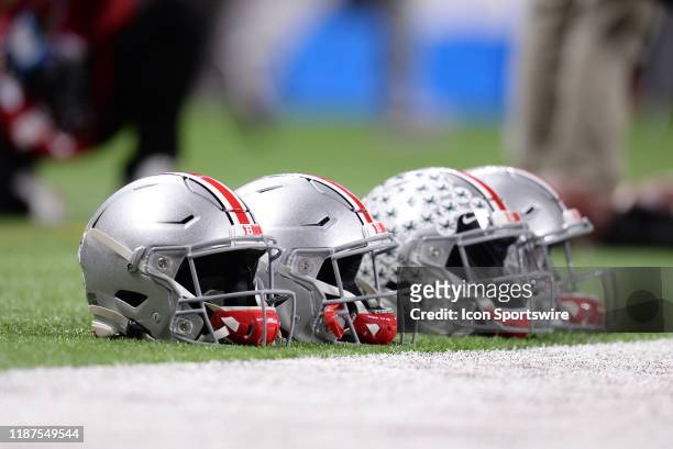 Ohio State Buckeyes football helmets sit on the sidelines before the start of the Big Ten Conference Championship football game between the Wisconsin...