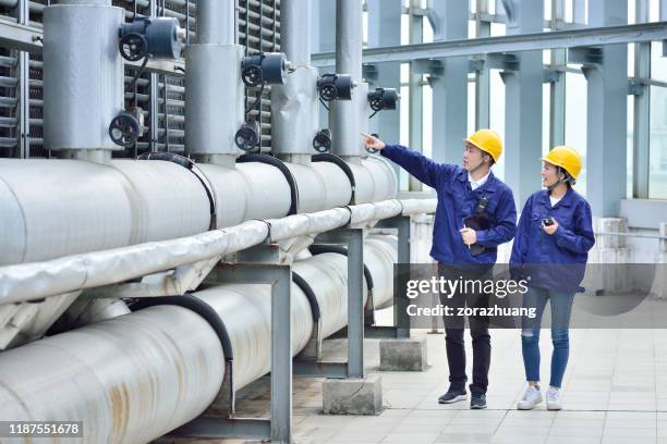 two engineer colleagues examining cooling tower equipment - chemical stock pictures, royalty-free photos & images