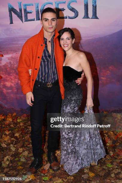 Charlotte Hervieux and a guest attend the "Frozen 2 - La Reine Des Neiges 2" Paris Gala Screening at Cinema Le Grand Rex on November 13, 2019 in...