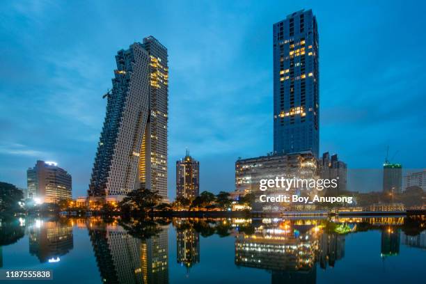 view of colombo skyline and cityscape at twilight look through beira lake a lake in the center of the city of colombo, sri lanka. - sri lanka skyline stock pictures, royalty-free photos & images