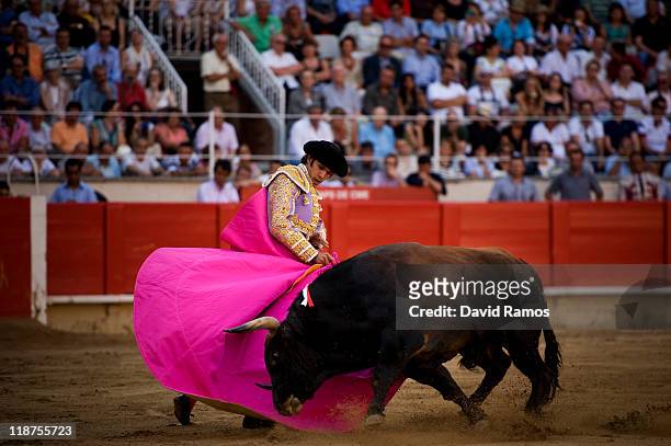Bullfighter Sebastian Castella of France performs during the second bullfight of the 2011 season at the Monumental bullring on July 10, 2011 in...