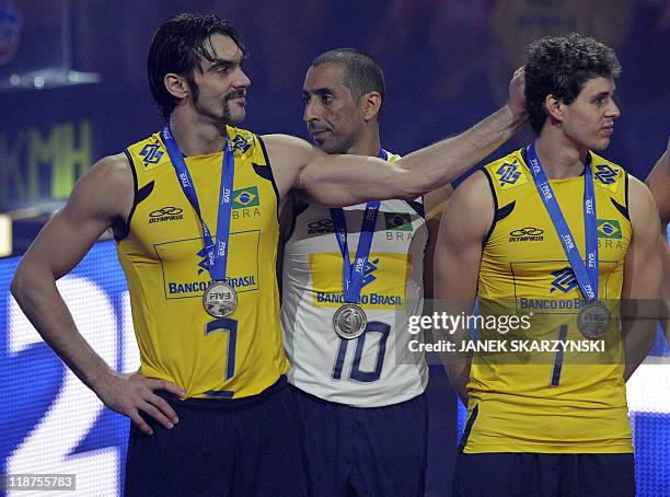 Brazil's players Gilberto Godoy Filho, Santos Sergio Dutra and Rezende Bruno Mossa react after winning the silver medal of the Volleyball World...