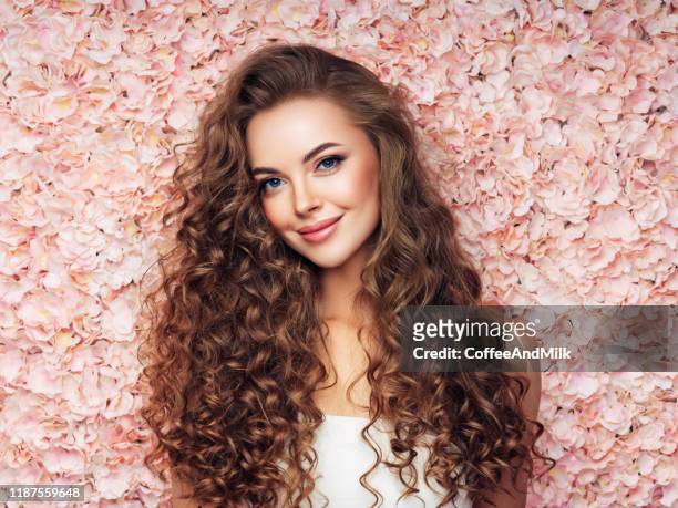 beautiful girl with long and curly hairs - woman pink dress stock pictures, royalty-free photos & images