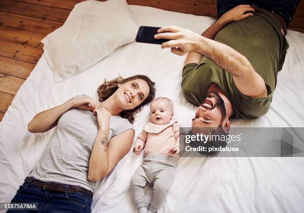 a picture of them and their bindle of joy - young couple with baby stock pictures, royalty-free photos & images