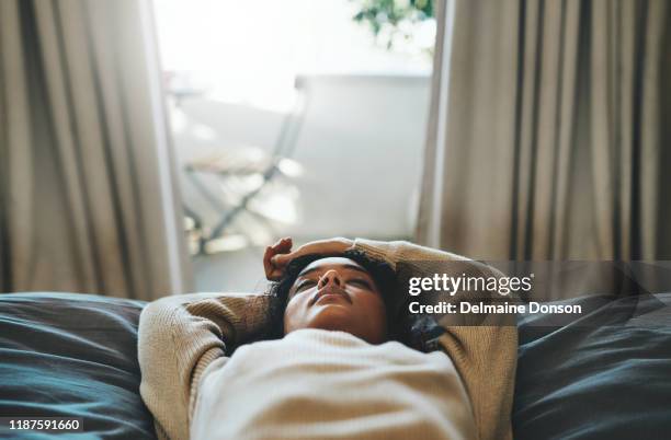 a power nap is just what i need - woman sleeping in bed stock pictures, royalty-free photos & images