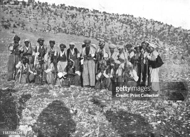 Ahmed Agha', circa 1906-1913, . Kurdish men with rifles and bullet belts, Shirwan, . 'A little further on we met Ahmed Agha and fifty gunmen. The...