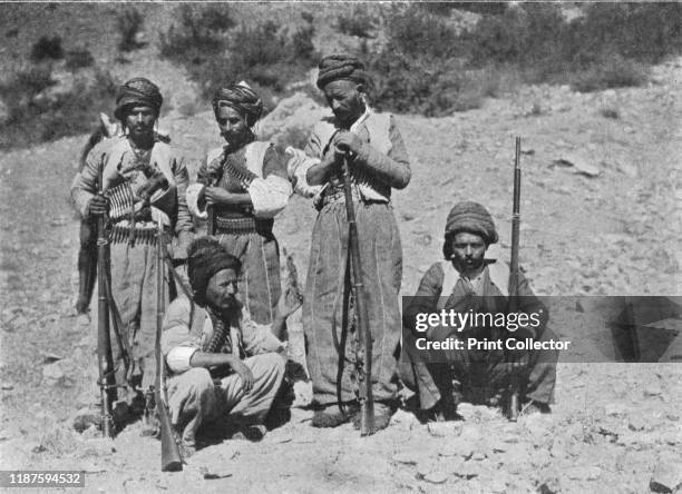 Kurds of Shaykh Sadik's 'Army'', circa 1906-1913, . Kurdish men with rifles and bullet belts, Khatuna, . From "The Caliphs' Last Heritage, a short...