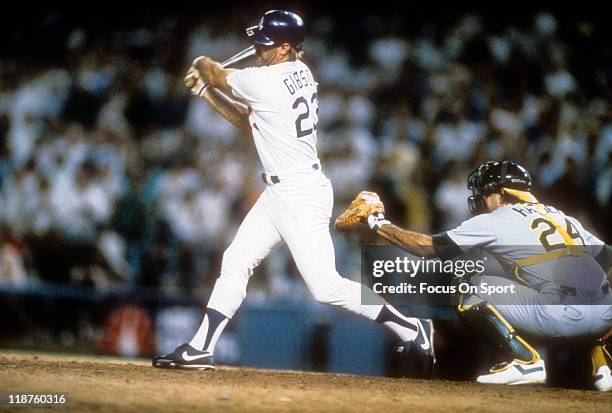 Kirk Gibson of the Los Angeles Dodgers bats in the bottom of the ninth inning of game one against the Oakland Athletics during the 1988 World Series,...